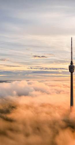 Stuttgarter Fernsehturm in den Wolken bei Sonnenaufgang
